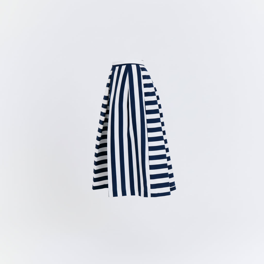 Navy and white striped skirt on a light gray background