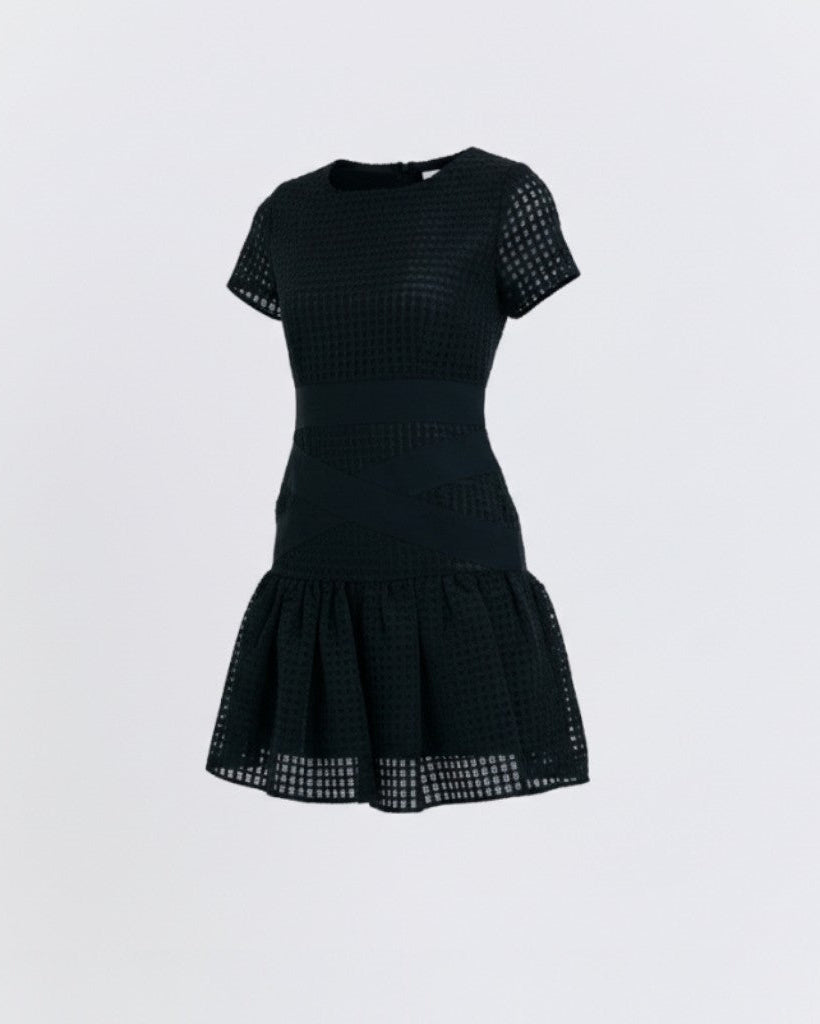 Black dress with mesh details on a light gray background