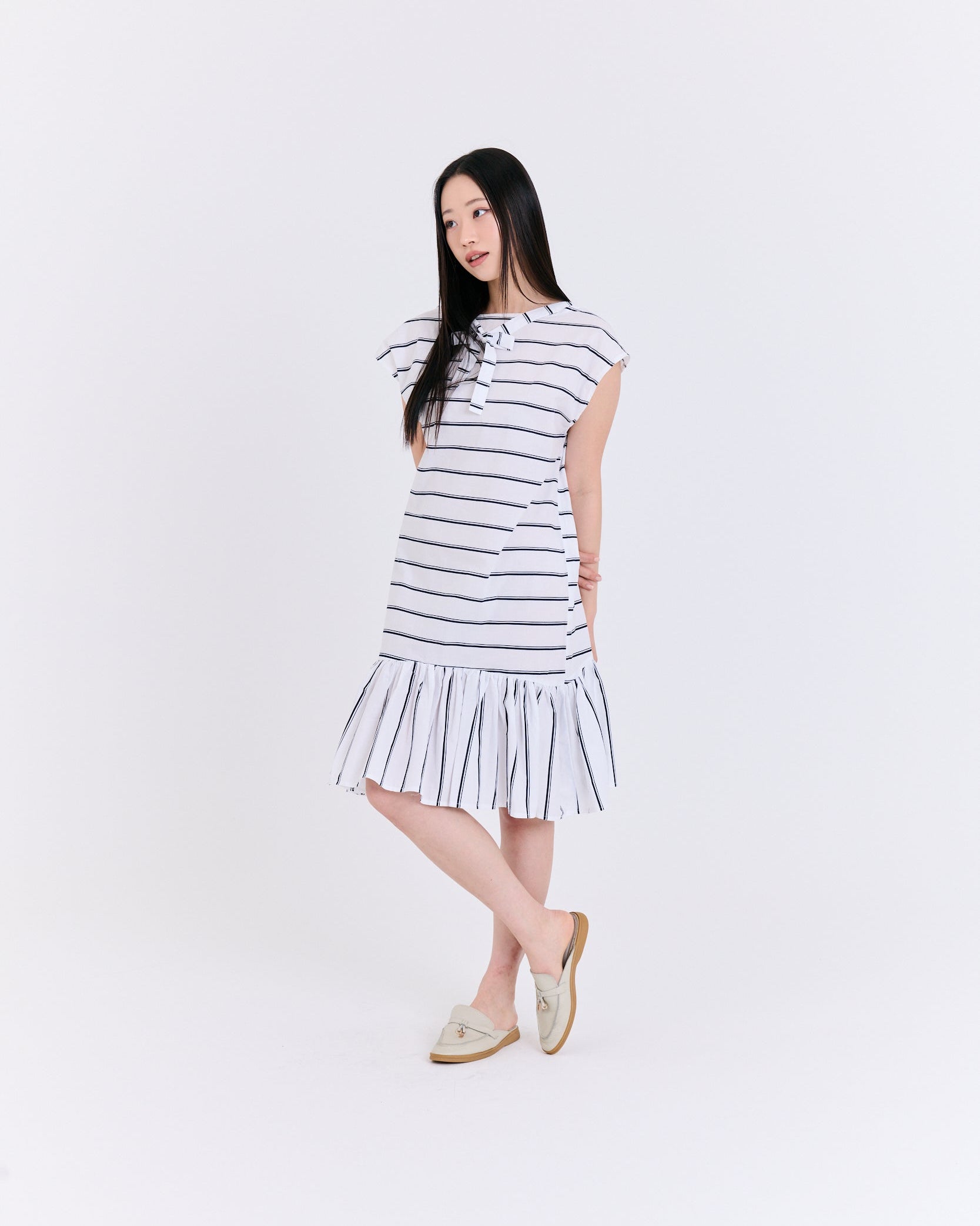 Woman wearing a striped dress on a white background
