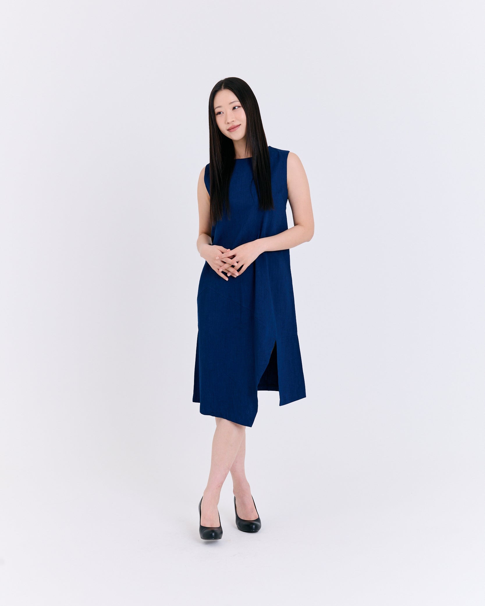 Woman wearing a blue dress on a white background