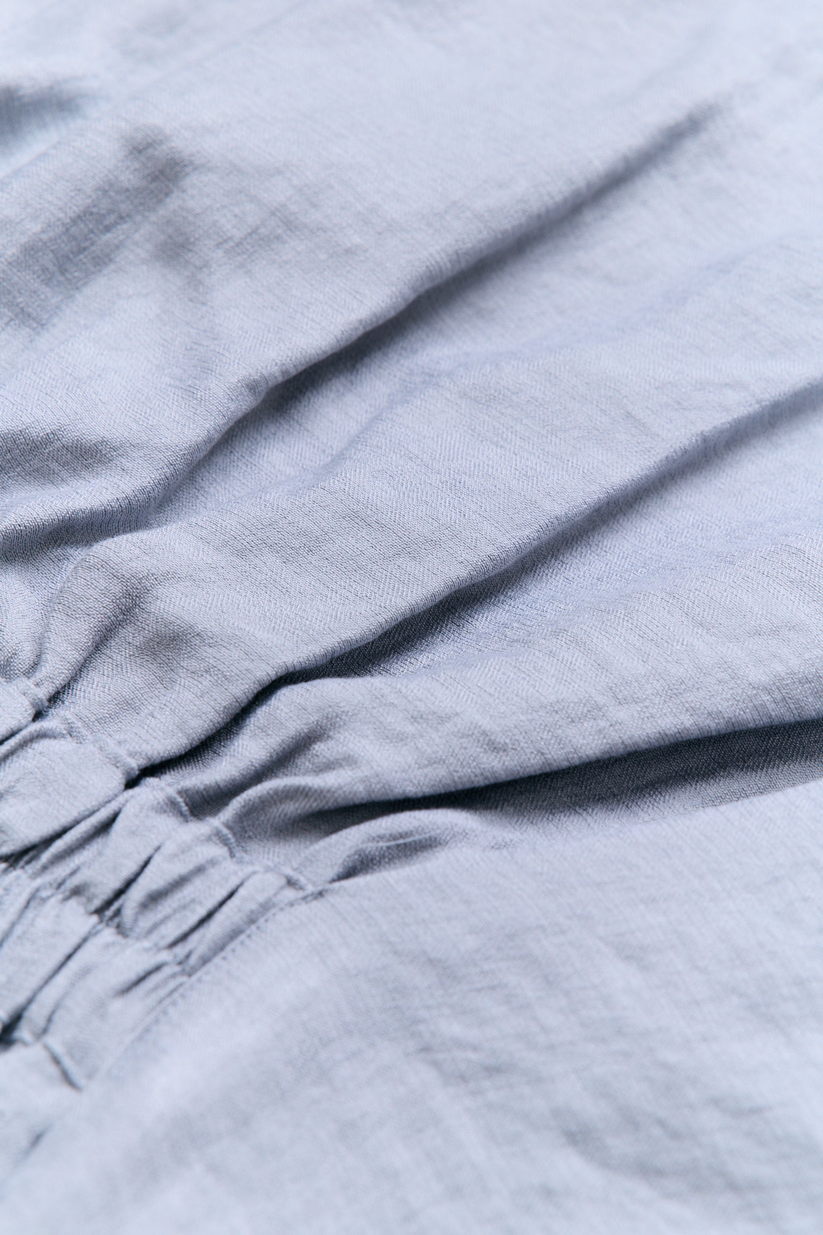 Close-up of light blue fabric with folds