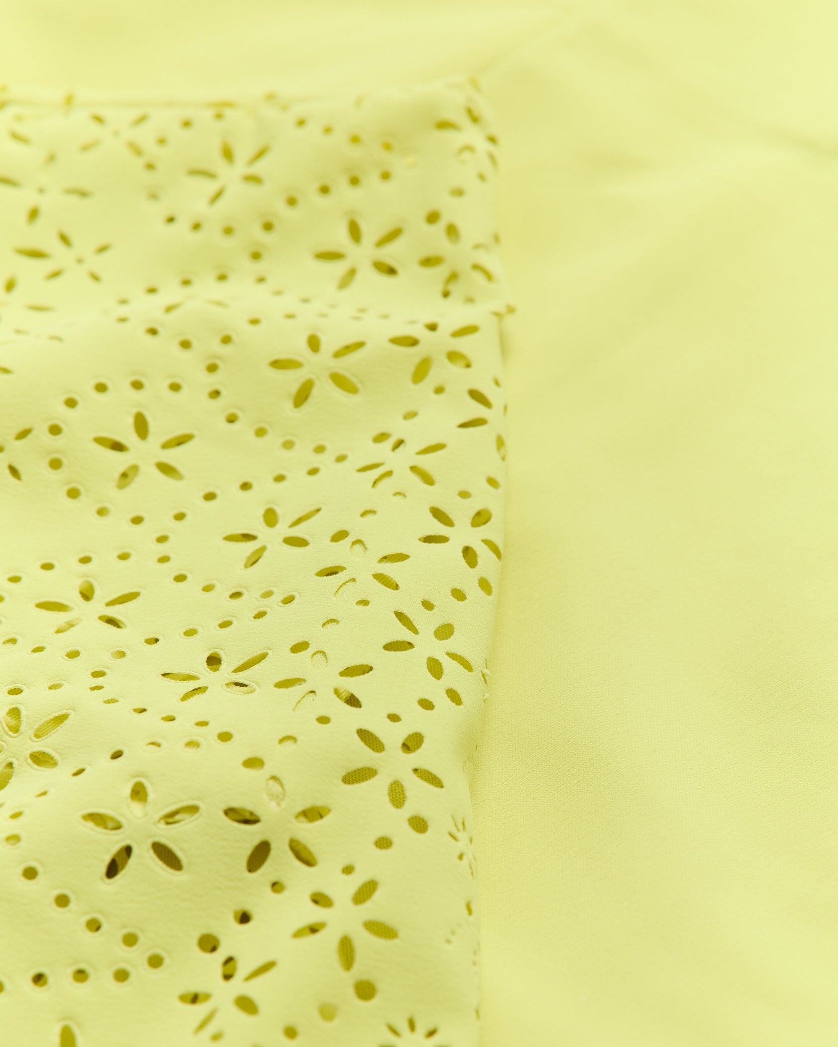 Light yellow fabric with a subtle pattern on a matching background