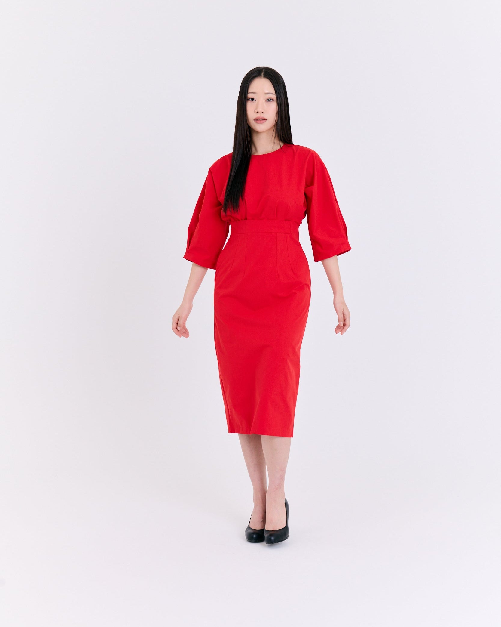 Woman wearing a red dress on a white background