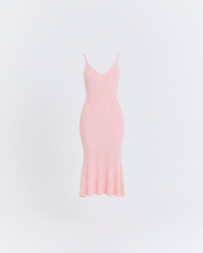 Pink slip dress on a light gray background