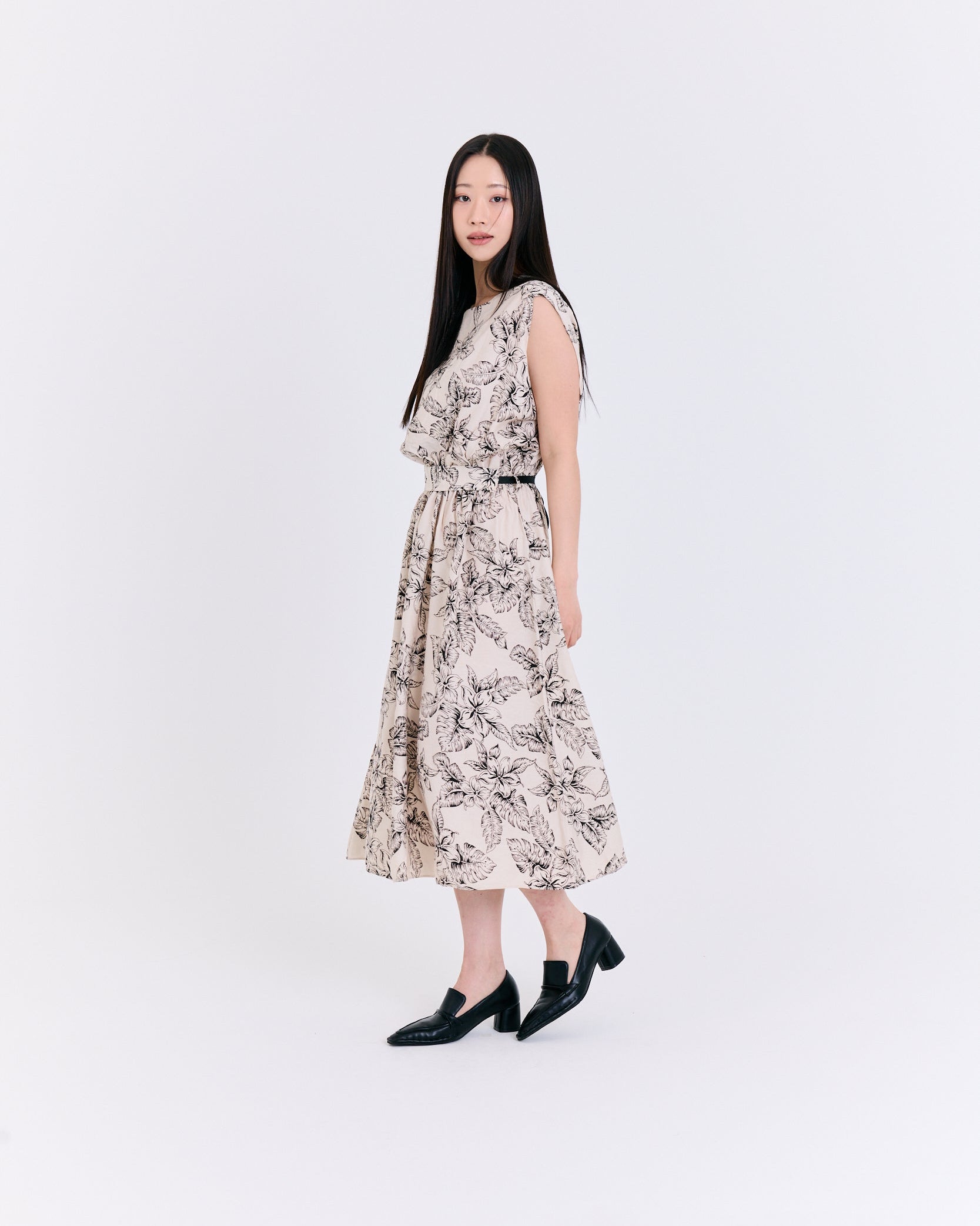 Woman wearing a floral dress on a white background