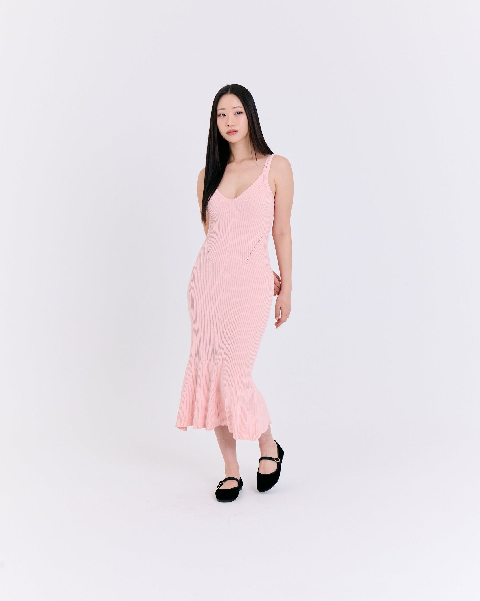Woman wearing a pink dress against a white background
