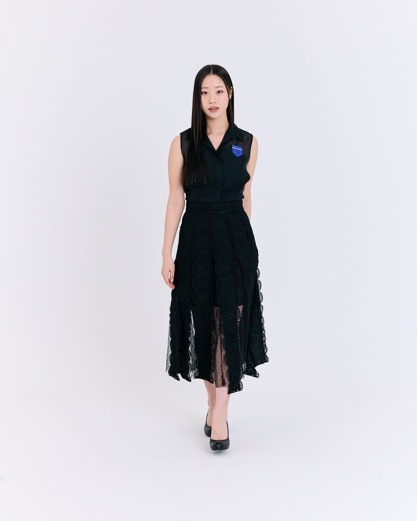 Woman wearing a black dress with a blue logo on a white background