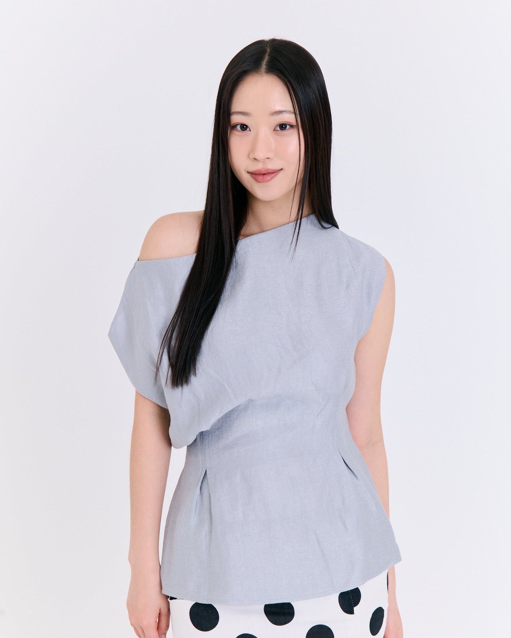 A light blue fabric top with folds