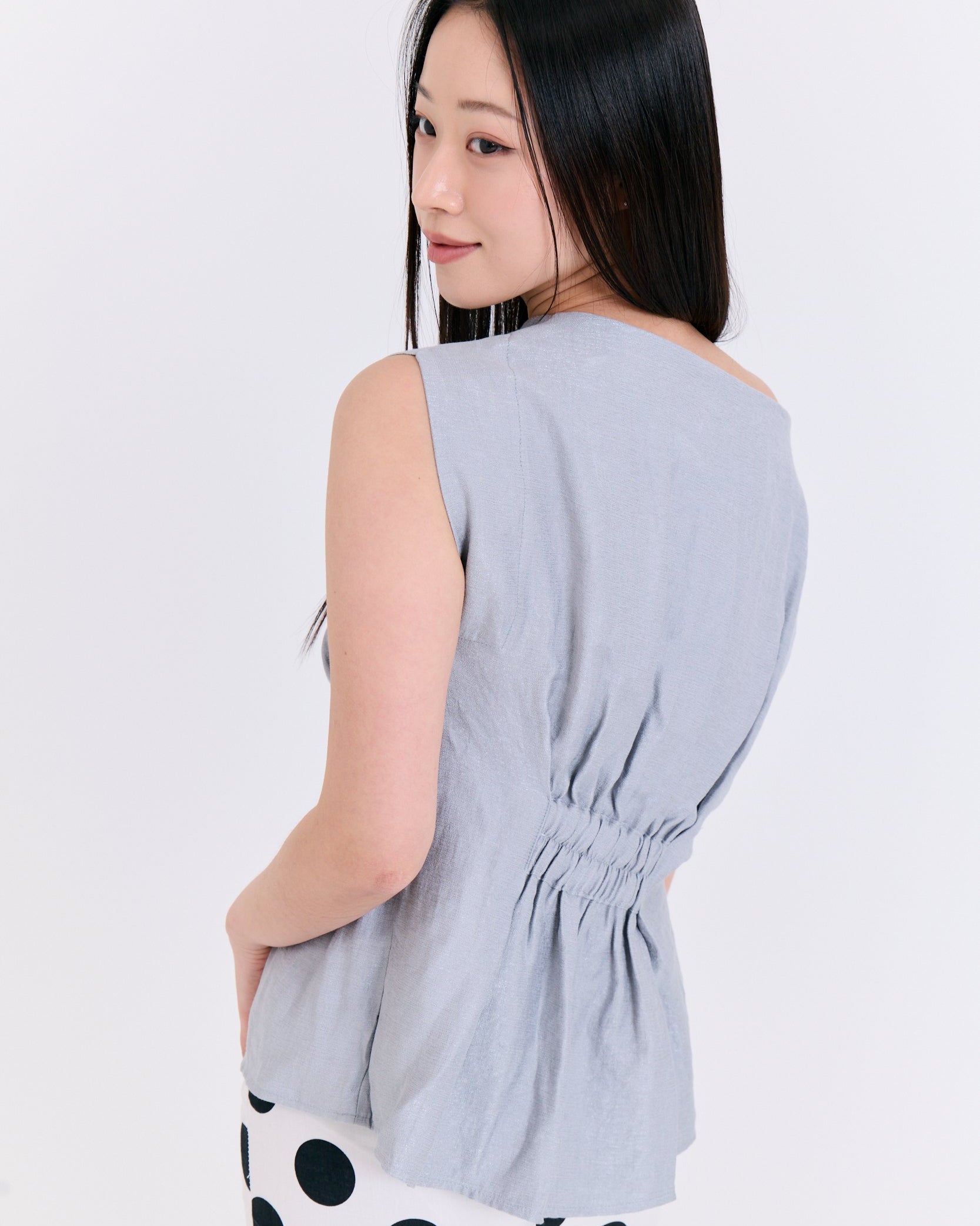 A light blue fabric top with folds