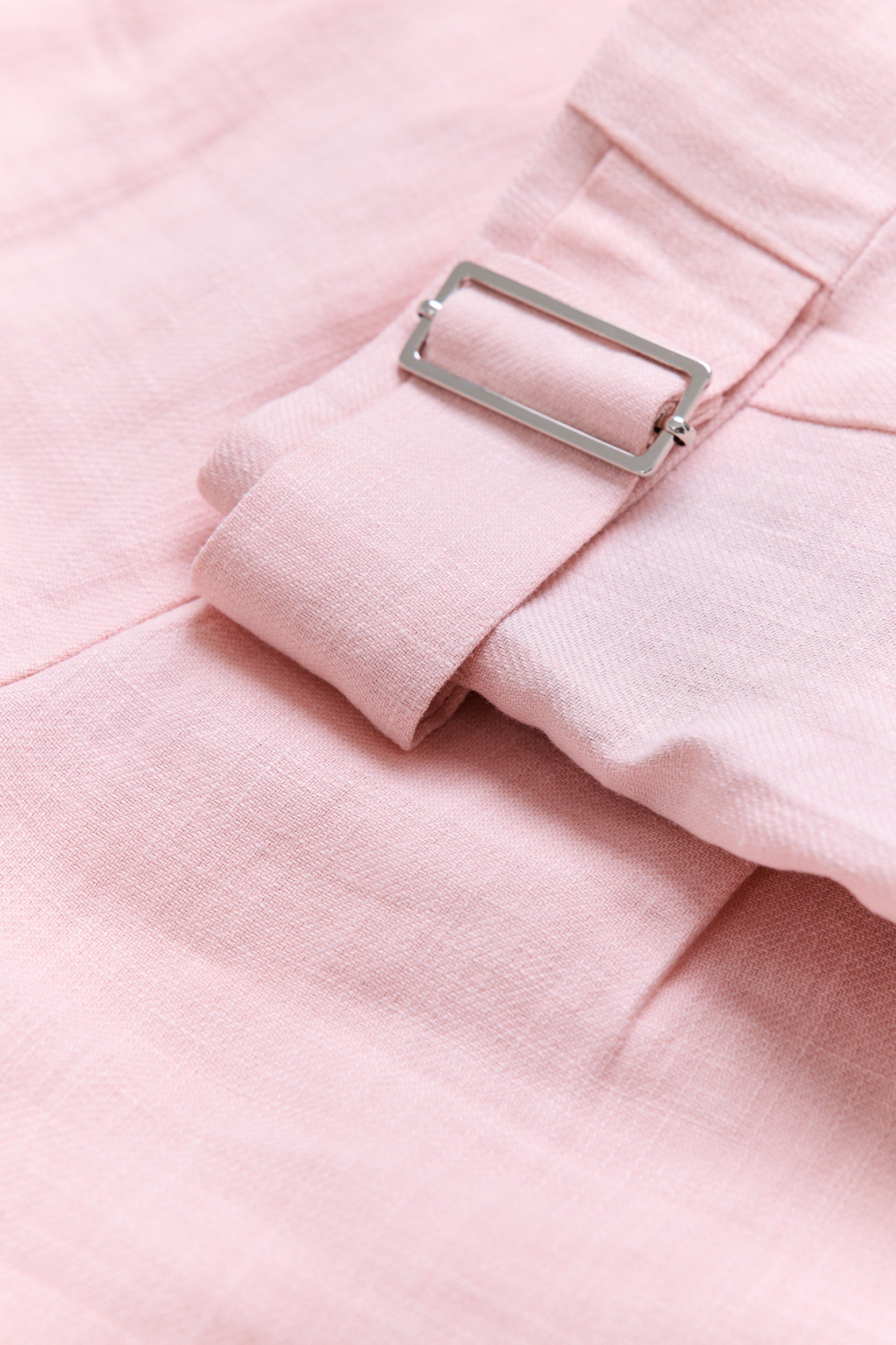 Close-up of a pink fabric with a metal buckle