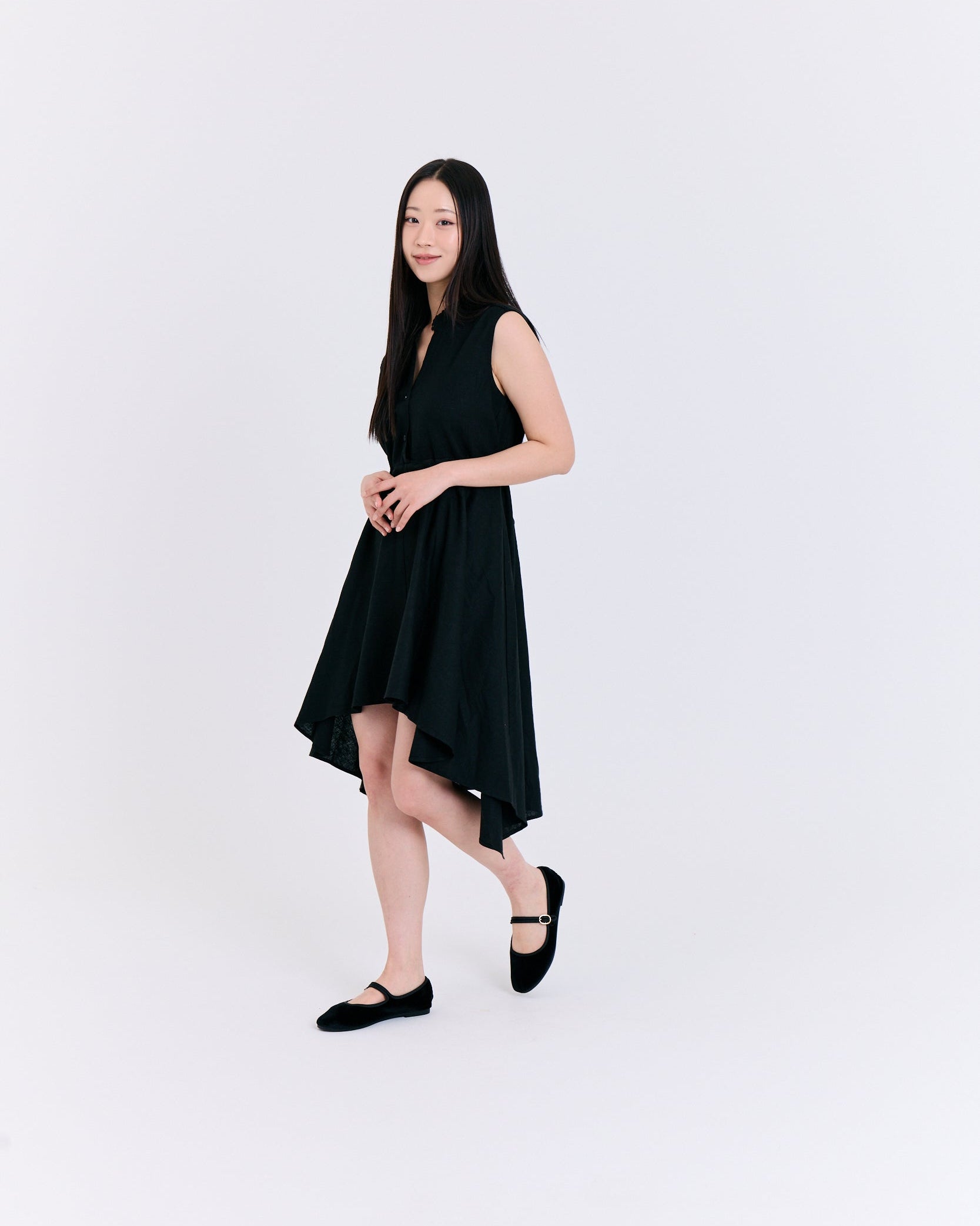 Woman wearing a black sleeveless dress on a white background